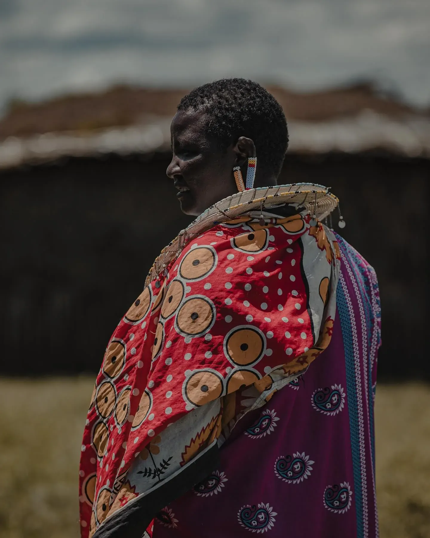 Maasai woman in profile wearing bright patterned cloth
