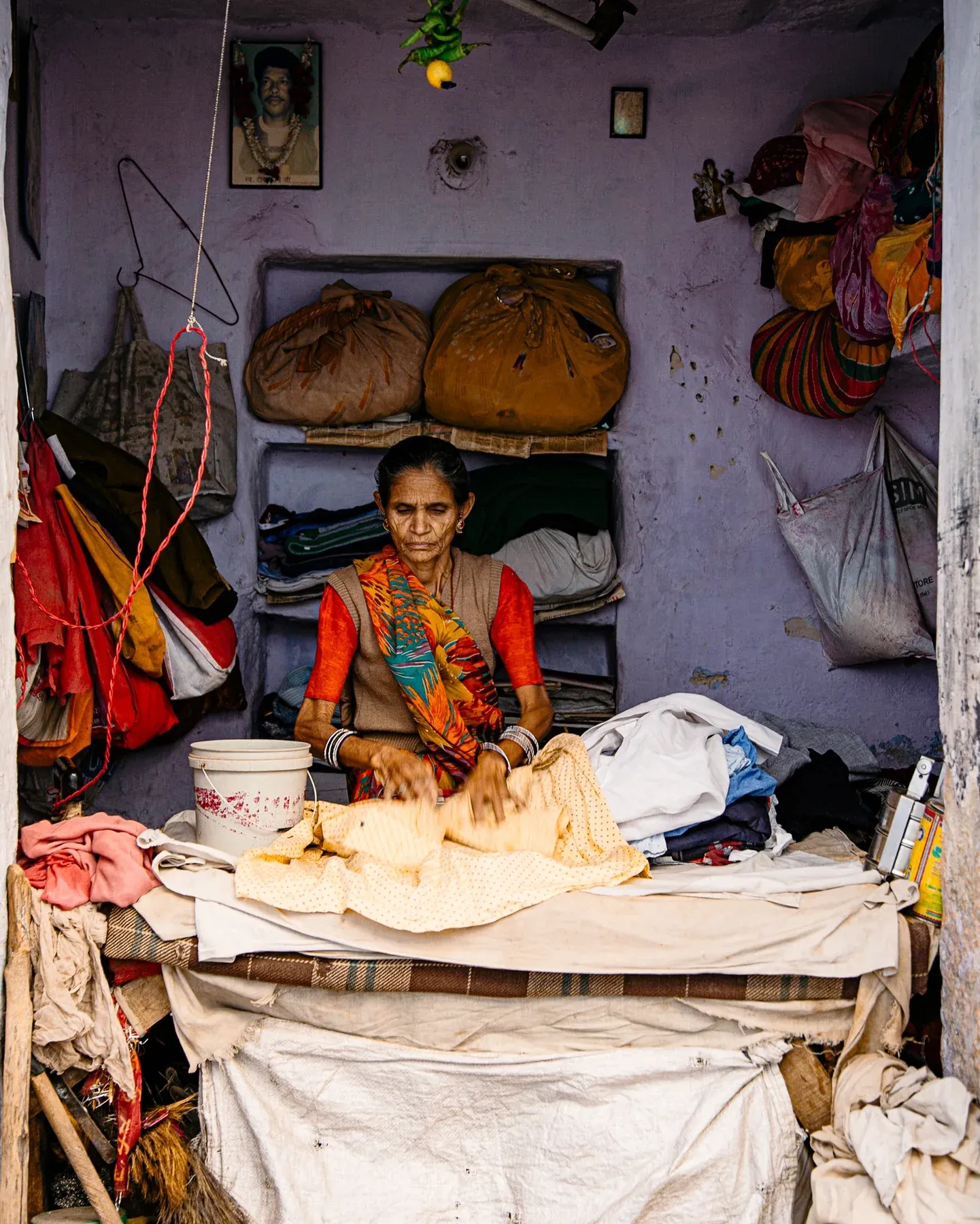 Woman working in a small lilac-walled shop