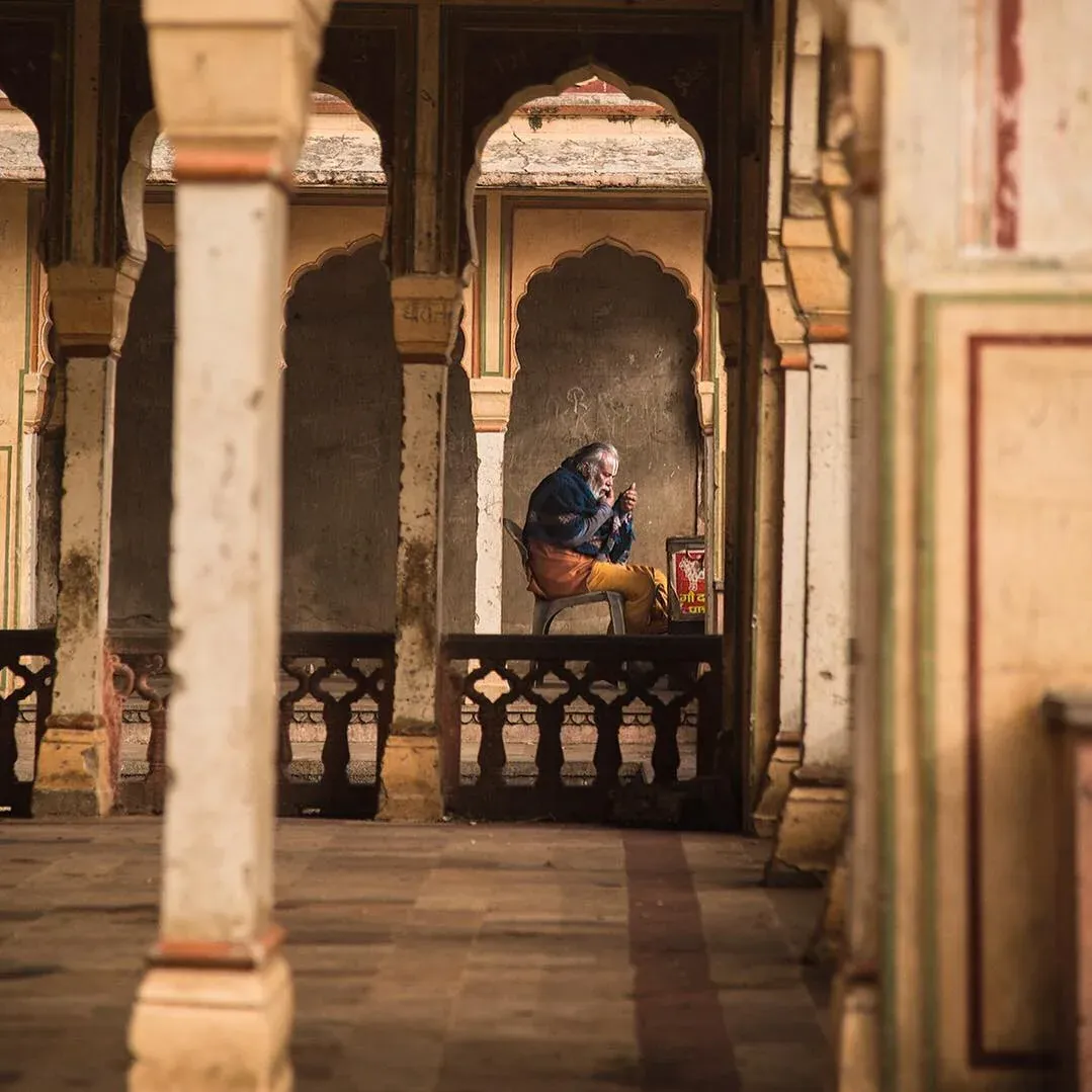 Man sitting in a pillared courtyard